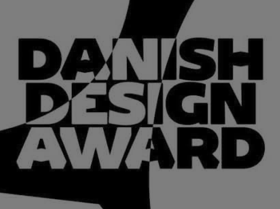 Danish Design Award logo in bold black lettering on a grey background.