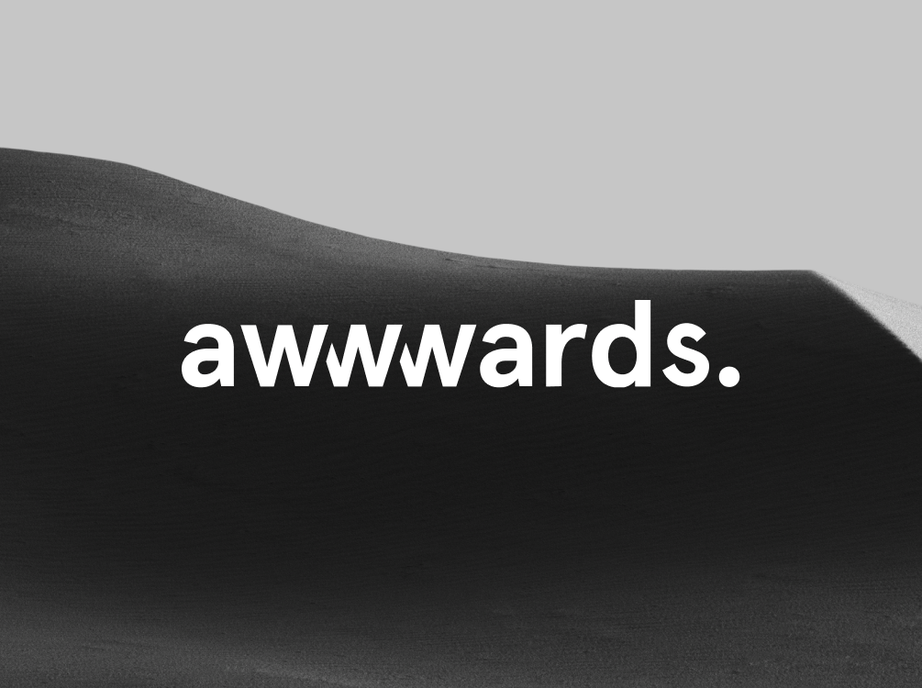 Awwwards logo in white over a dark sand dune in black and white.