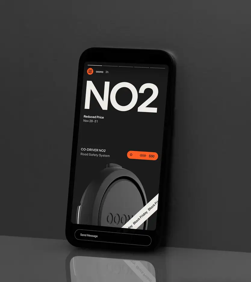 A phone propped against a dark surface displaying an Instagram-story-style ad: the "OOONO" logo and username, a large "NO2" headline, "Reduced Price / Nov 29–31," a "CO-DRIVER NO2 Road Safety System" listing with price dropping from $50 to $30, a photo of the device, a diagonal "Black Friday" ribbon, and a "Send Message" bar.