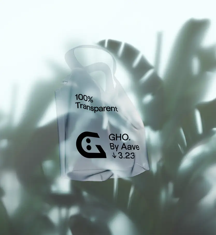 A frosted, semi-transparent plastic tote bag floating against a soft, dreamy blurred background of tropical leaves in cool blue-green tones. The bag is printed with black graphics: "100% Transparent" near the top, and the stylized "G" face logo (a rounded letter with two dot-like eyes) beside the text "GHO. By Aave ↓ 3.23" lower down. Misty light filters through the foliage, giving the scene an ethereal, atmospheric mood.
