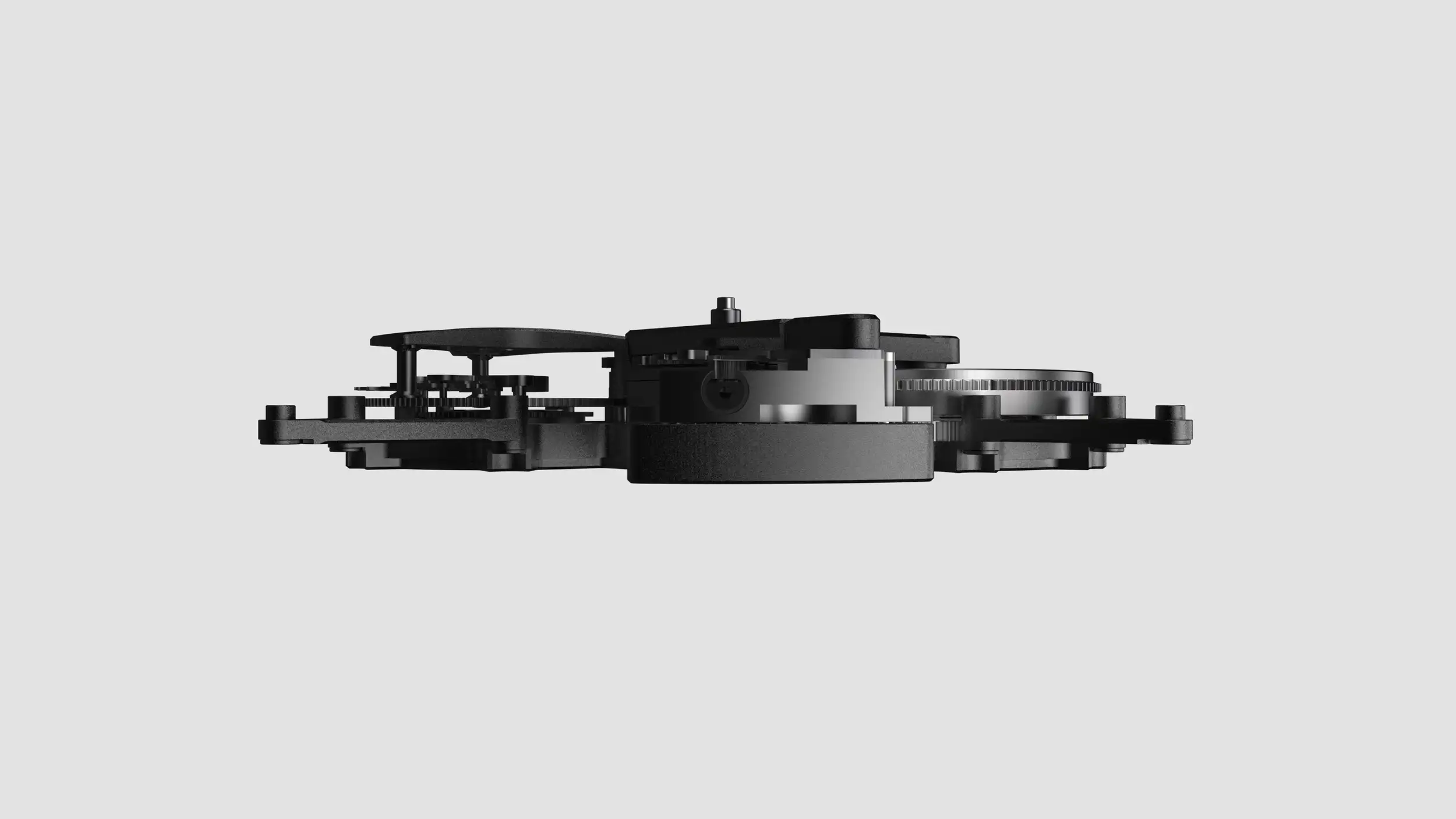 A clean product render showing the side profile of a black watch movement (the internal mechanism) isolated against a plain light gray background. The intricate mechanical assembly is rendered mostly in matte black with a few polished silver metal accents, revealing layered plates, bridges, a large barrel or drum in the center, and toothed gear wheels at both ends. The minimalist studio presentation emphasizes the low, flat architecture and precision engineering of the movement.