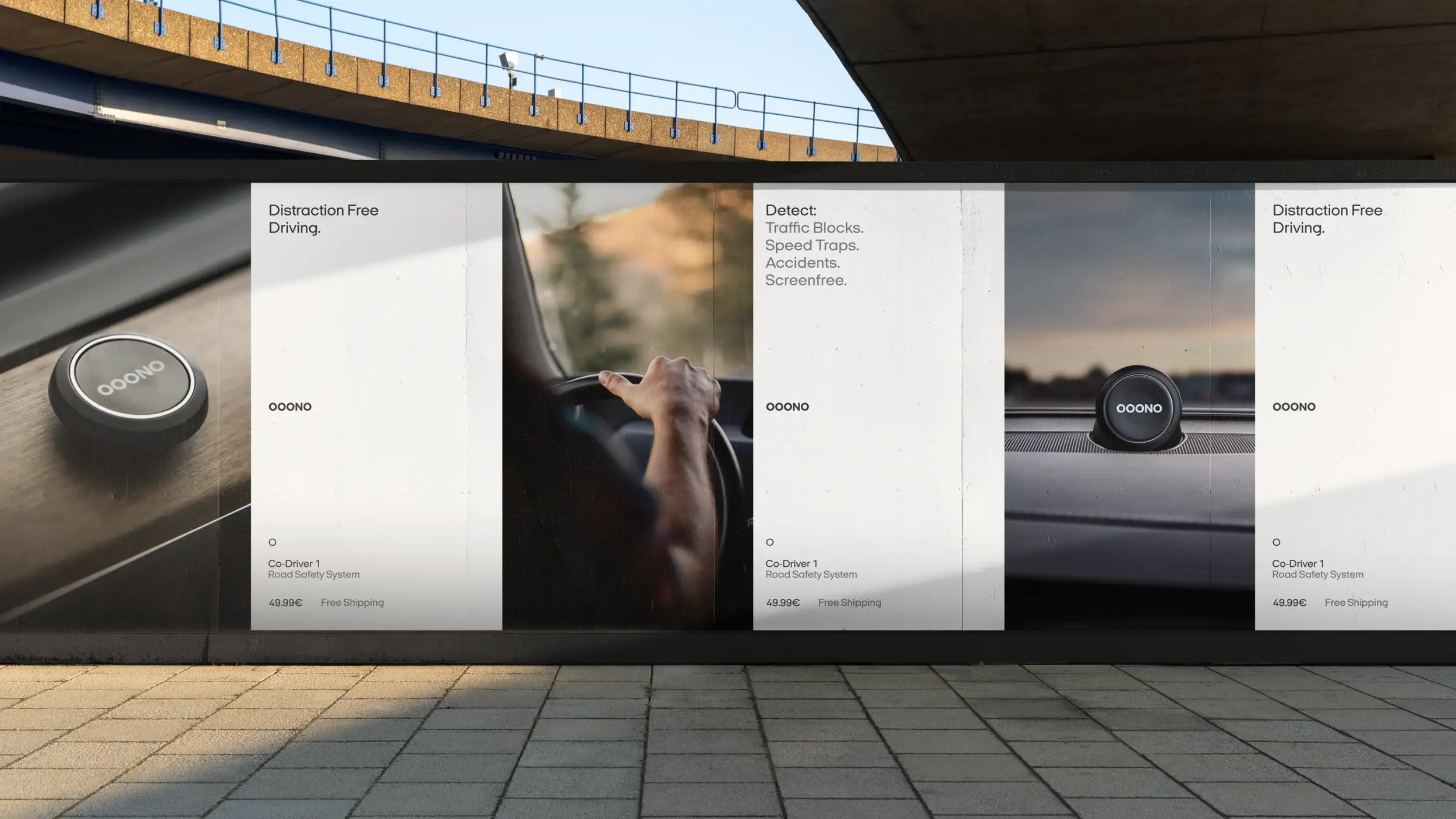Wide outdoor billboard mounted beneath a concrete overpass. Three product panels advertise the OOONO Co-Driver 1 Road Safety System (49.99€, free shipping): a close-up of the black circular device, a driver's hand on a steering wheel, and the device mounted on a car dashboard. Text reads "Distraction Free Driving" and "Detect: Traffic Blocks. Speed Traps. Accidents. Screenfree."