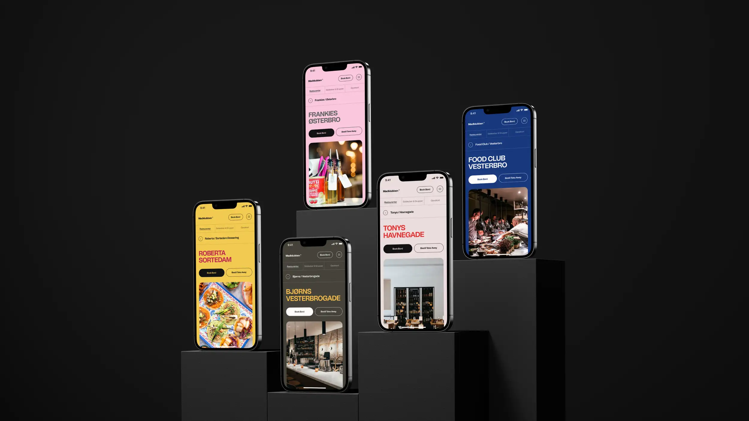 Five smartphone mockups displayed on dark pedestals of varying heights against a black background, each showing a different Madklubben restaurant page in its own brand color. From left to right: Roberta Sortedam on a yellow background with a photo of colorful tacos, Bjørns Vesterbrogade on an olive-dark background with a photo of a bar counter, Frankies Østerbro on a pink background with a photo of bottles and glassware, Tonys Havnegade on a light pink background with a photo of a wine display, and Food Club Vesterbro on a blue background with a photo of a busy dining room. Each screen includes matching 'Book Bord' and 'Bestil Take Away' buttons in colors that complement its background.
