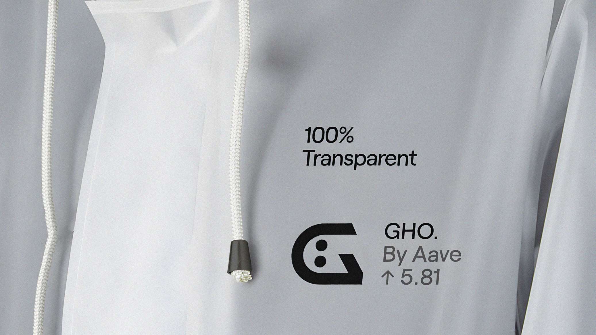 Close-up of a white garment with a drawstring, featuring text: "100% Transparent," "GHO. By Aave ↑ 5.81," and a logo.