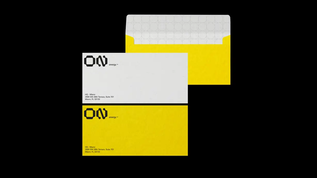Two envelope mockups, one white and one yellow, both printed with the black ON energy logo and a Miami headquarters address, shown closed and open.