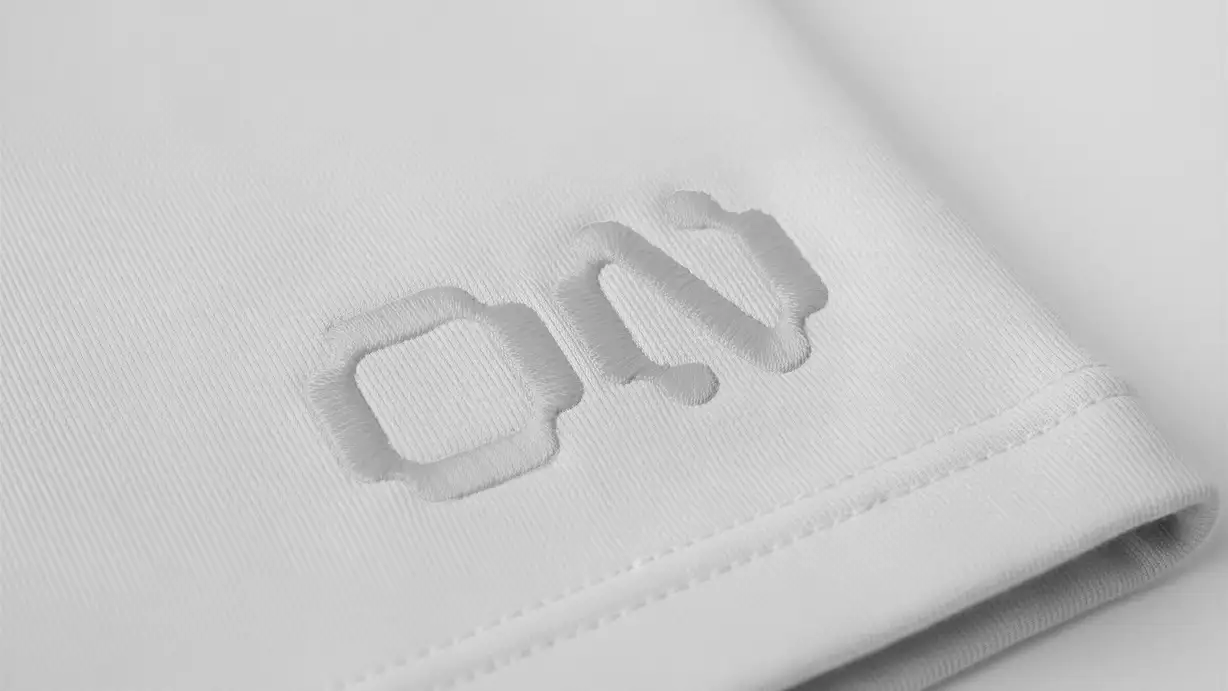 Close-up of a folded white fabric cuff with the ON logo embroidered in tone-on-tone white thread.