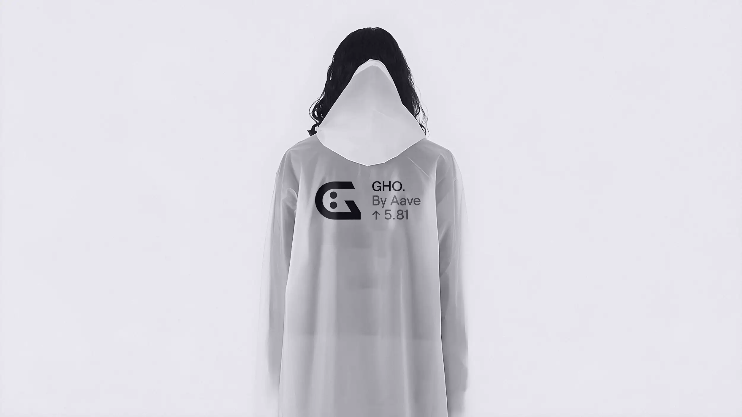 A person stands facing the camera against a plain off-white background, wearing a long, translucent frosted-white hooded raincoat pulled entirely over their head so the face is completely concealed, creating a ghostly, anonymous silhouette. Long dark hair spills out from beneath the hood on both sides. Printed across the chest is a stylized "G" logo (a rounded letter with two dot-like eyes forming a face) beside the text "GHO. By Aave ↑ 5.81." The overall image is nearly monochrome and minimalist.